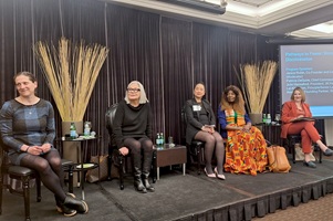 The five Pathways to Power anniversary session panelists seated on a raised stage, side by side