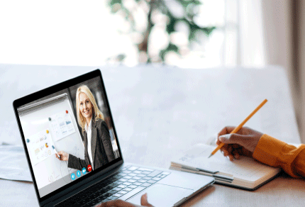 Professional participating in a virtual meeting while taking notes
