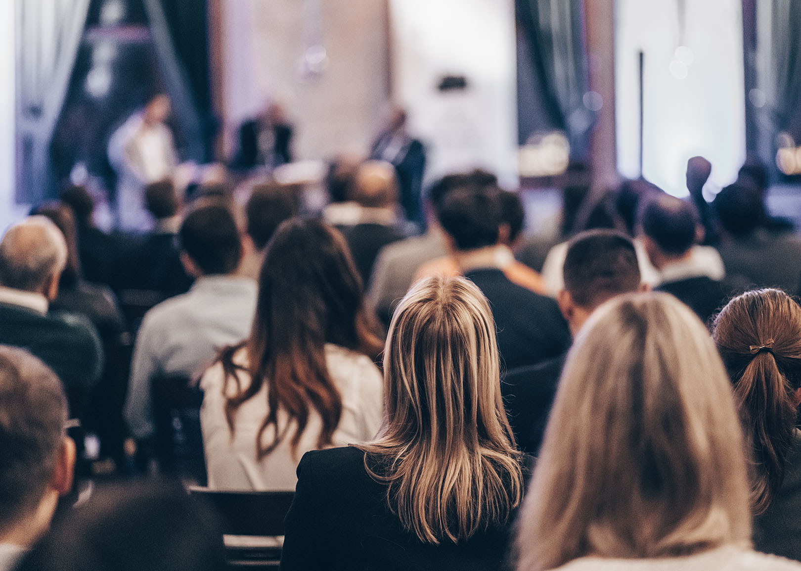 Large group of people listening to a public speaker.