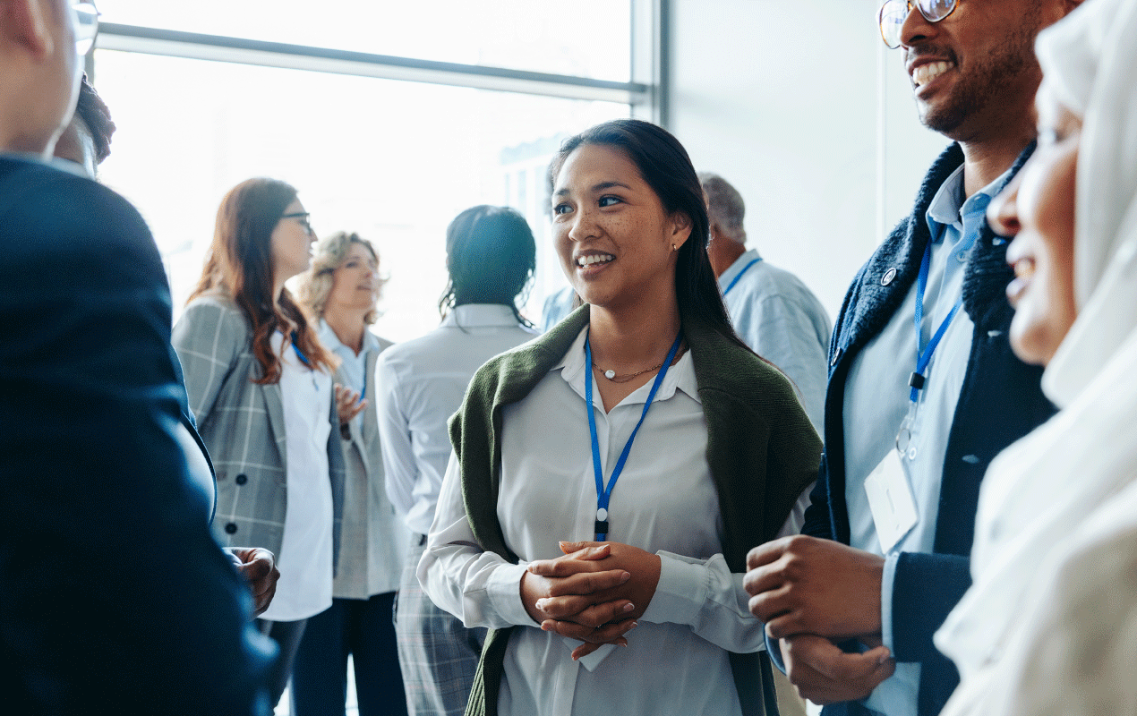 Professionals networking and exchanging ideas in a conference setting.