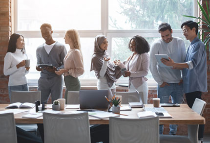 Business team having a discussion during a break in an office setting.