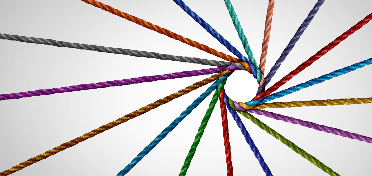 A collection of colorful sticks or wires arranged in a radial pattern, converging at a central point, creating a visually striking geometric design