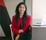 photo of Yameena Ansari, seated at office desk