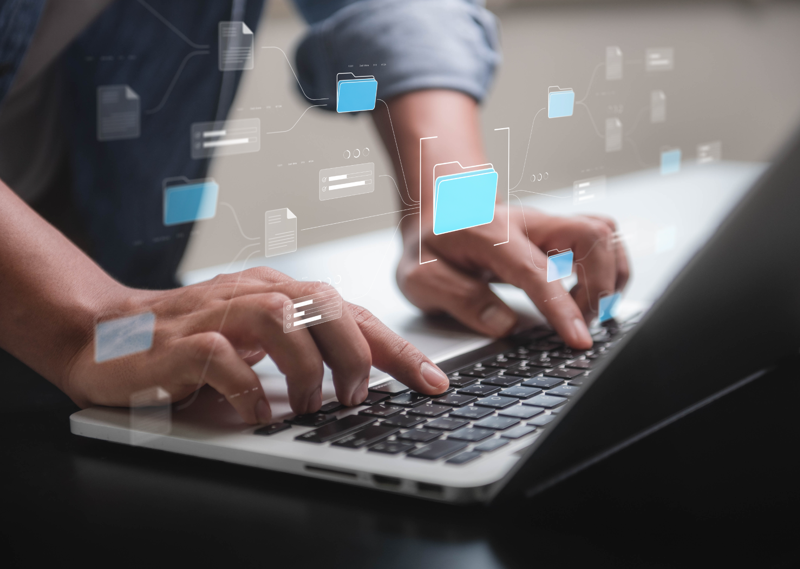 Close-up of hands typing on a laptop keyboard with digital icons of folders and files appearing above, symbolizing data management or cloud computing.