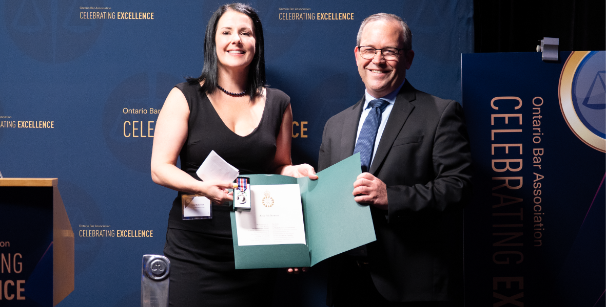 Kelly McDermott receiving the King Charles III Coronation Medal presented by Attorney General Doug Downey