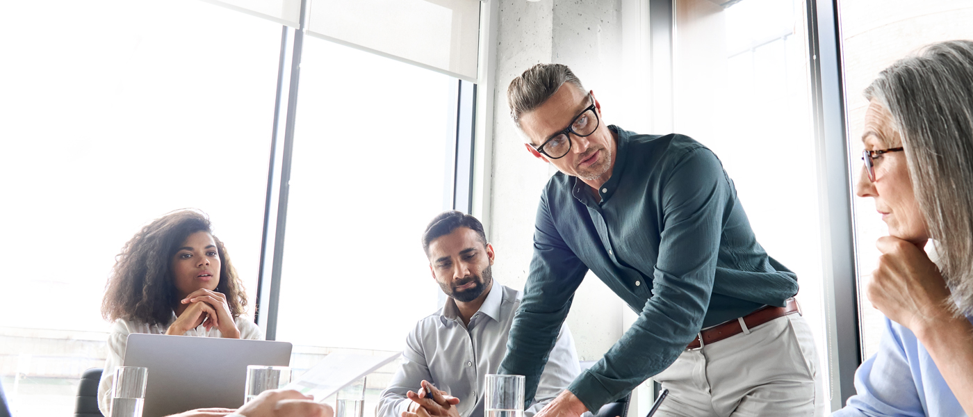 A group of diverse professionals in a modern office, engaged in a lively and collaborative discussion.