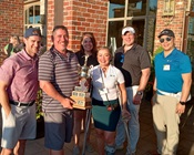 Golf Day winning team poses with trophy