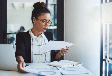 Lawyer reviewing documents while working at a desk