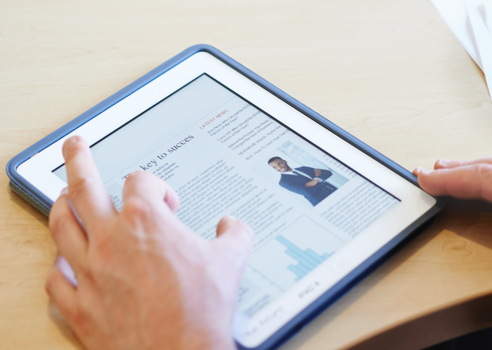 Person using a tablet to read an article featuring text, a chart, and an image of a professional on the screen.