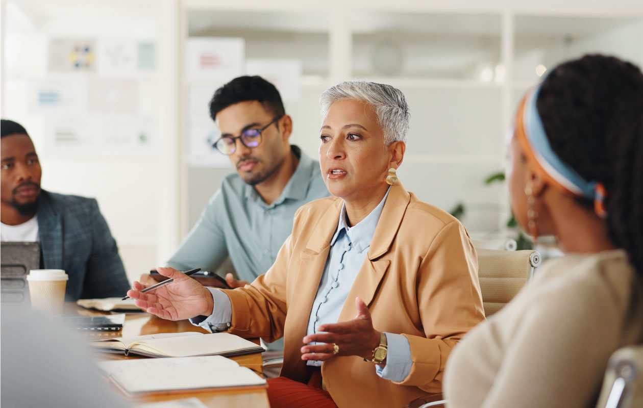 Diverse group of professionals participating in a boardroom discussion.