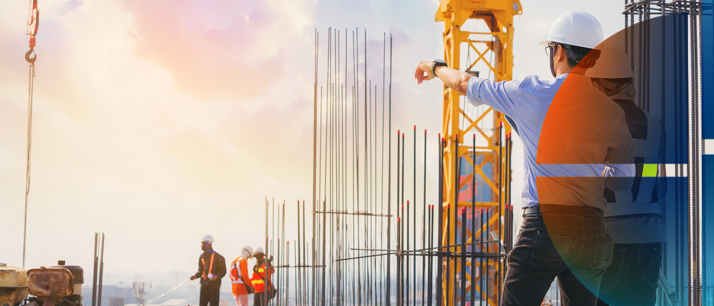 Construction workers on-site, with a supervisor in a safety vest and helmet overseeing the progress of a building project.