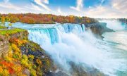 Photo of Niagara Falls surrounded by colourful fall foliage