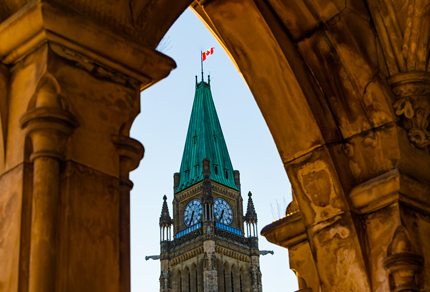 Peace Tower at the Parliament of Canada framed in an arch.