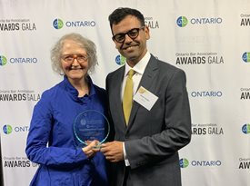 Jennifer Chambers, representing the Empowerment Council, accepts the OBA Foundation Award from OBA Foundation Trustee Mohsen Seddigh