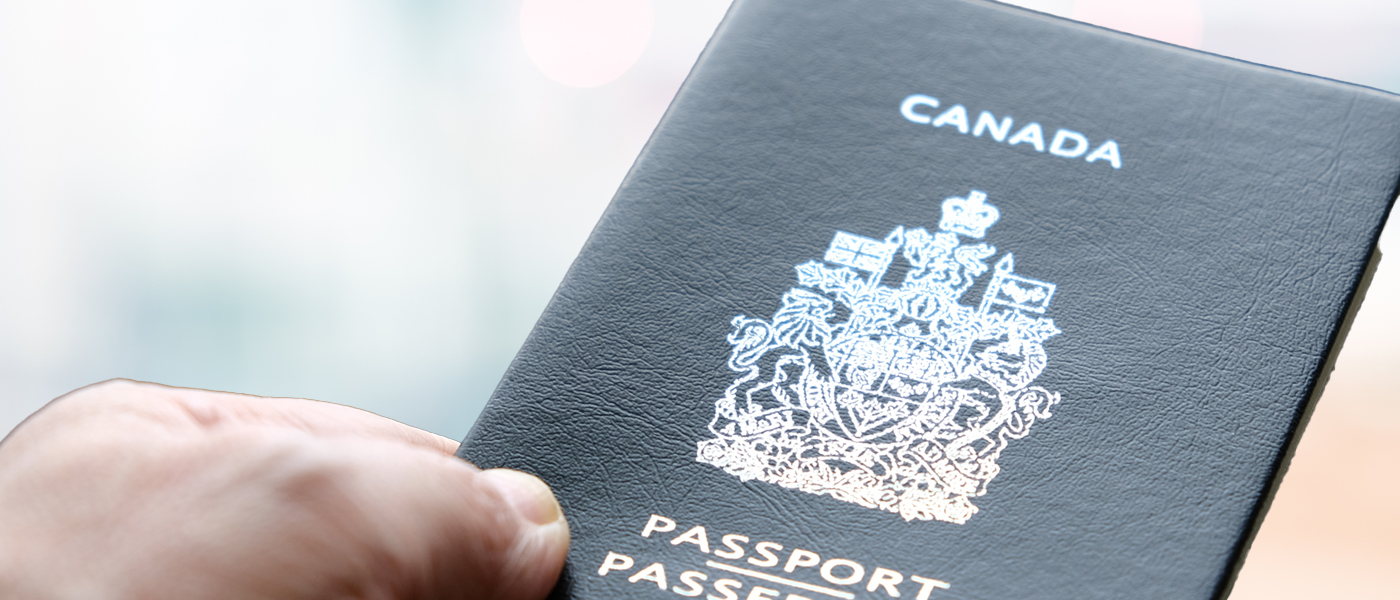 Close-up of a person holding a Canadian passport.